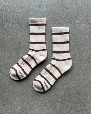 Pair of striped socks on a gray surface