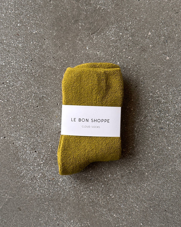 Green sock with a white label on a gray surface