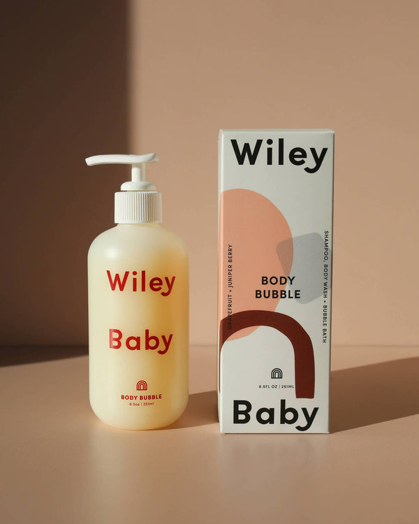 Wiley Baby body bubble bottle and packaging on a beige background