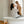 Woman and child in a bathroom with a bathtub and window in the background