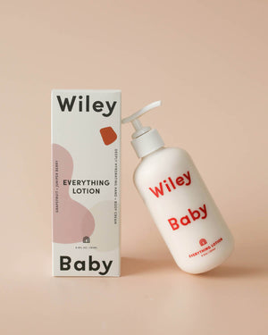Wiley Baby lotion bottle and packaging on a beige background