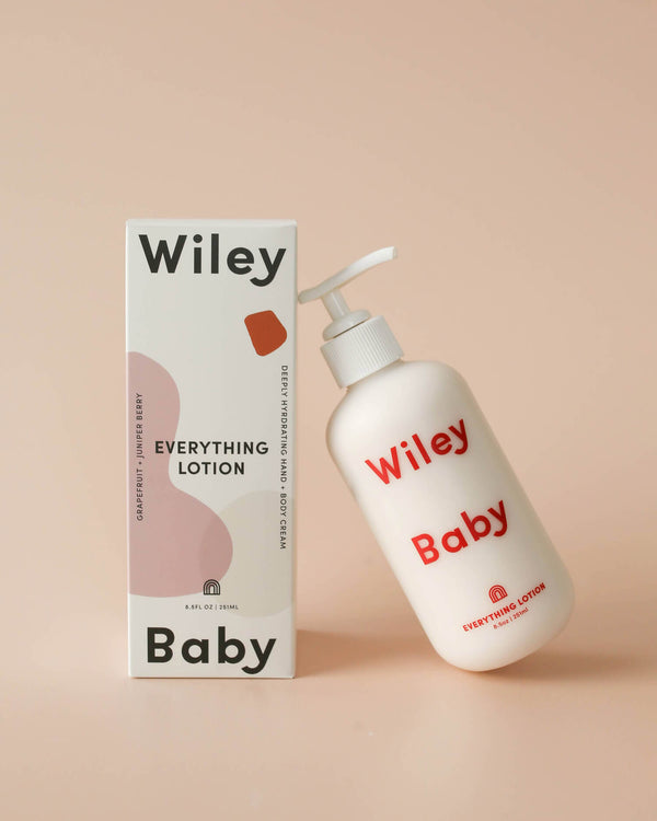 Wiley Baby lotion bottle and packaging on a beige background