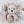 Crocheted bear rattle with wooden ring on a textured beige background