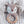 Crocheted fox rattle with wooden ring on a textured surface