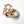 Wooden teething ring with a monkey cut-out and tan silicone beads on a white background