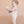 Child in a white romper holding a teddy bear against a beige background