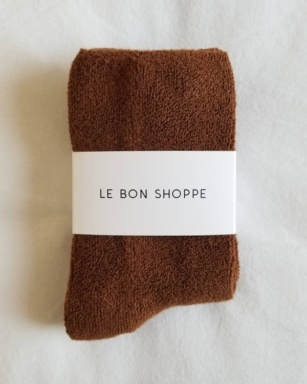 Brown socks with a white label reading 'Le Bon Shoppe' on a light background