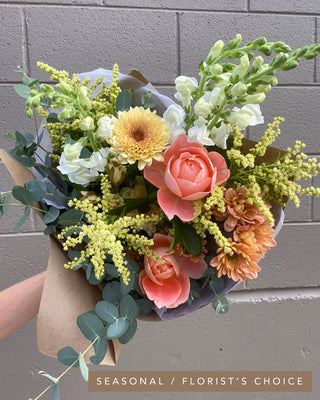Classic bouquet in a seasonal florist’s choice palette with garden roses, snapdragons, mums, and eucalyptus.