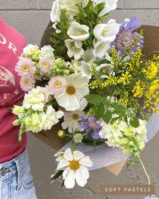 Classic bouquet in a soft pastel palette with cosmos, scabiosa, snapdragons, and delicate seasonal flowers.