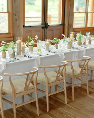 Wedding reception tables with seasonal floral centerpieces and elegant place settings.