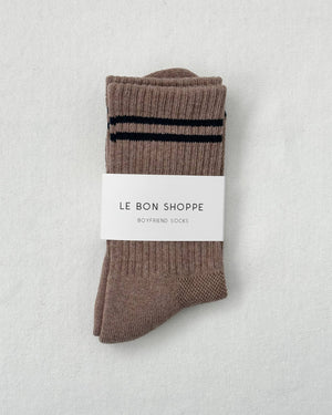 Pair of brown socks with a black stripe on a light gray background, featuring 'Le Bon Shoppe' label.