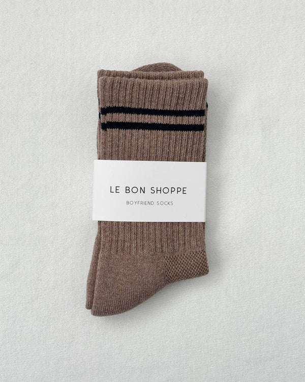Pair of brown socks with a black stripe on a light gray background, featuring 'Le Bon Shoppe' label.