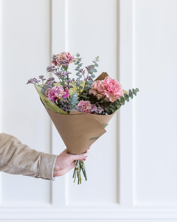 Hand-held bouquet with airy pink blooms, eucalyptus, and delicate textures, arranged in Landfall’s petite, artful Darling Bouquet style.