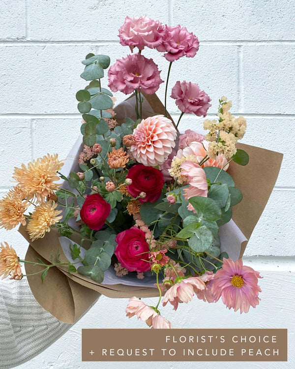 Luxe bouquet in a seasonal florist’s choice palette with dahlias, ranunculus, lisianthus, and eucalyptus.