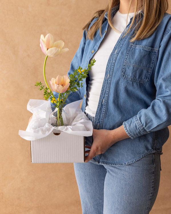 Mother's Day Bud Vase presented in a white gift box with tissue paper, held by a person — ready to gift from Landfall Floral Co. in Edgewater.