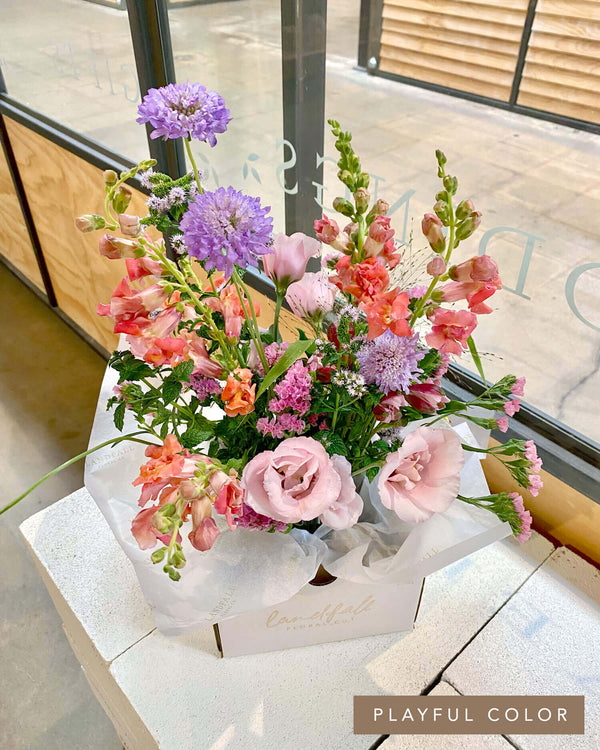 Signature Arrangement in a playful color palette featuring lisianthus, snapdragons, scabiosa, and seasonal blooms, designed in Landfall’s airy, delicate style.